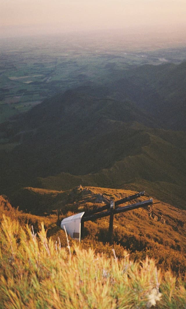 mountain landscape grass hills valley sky horizon sunset sunrise nature outdoors scenery view panorama field vegetation slope peak ridge golden brown green blue yellow sunlight shadow tranquility peaceful remote serene rural countryside travel exploration adventure primary color brown