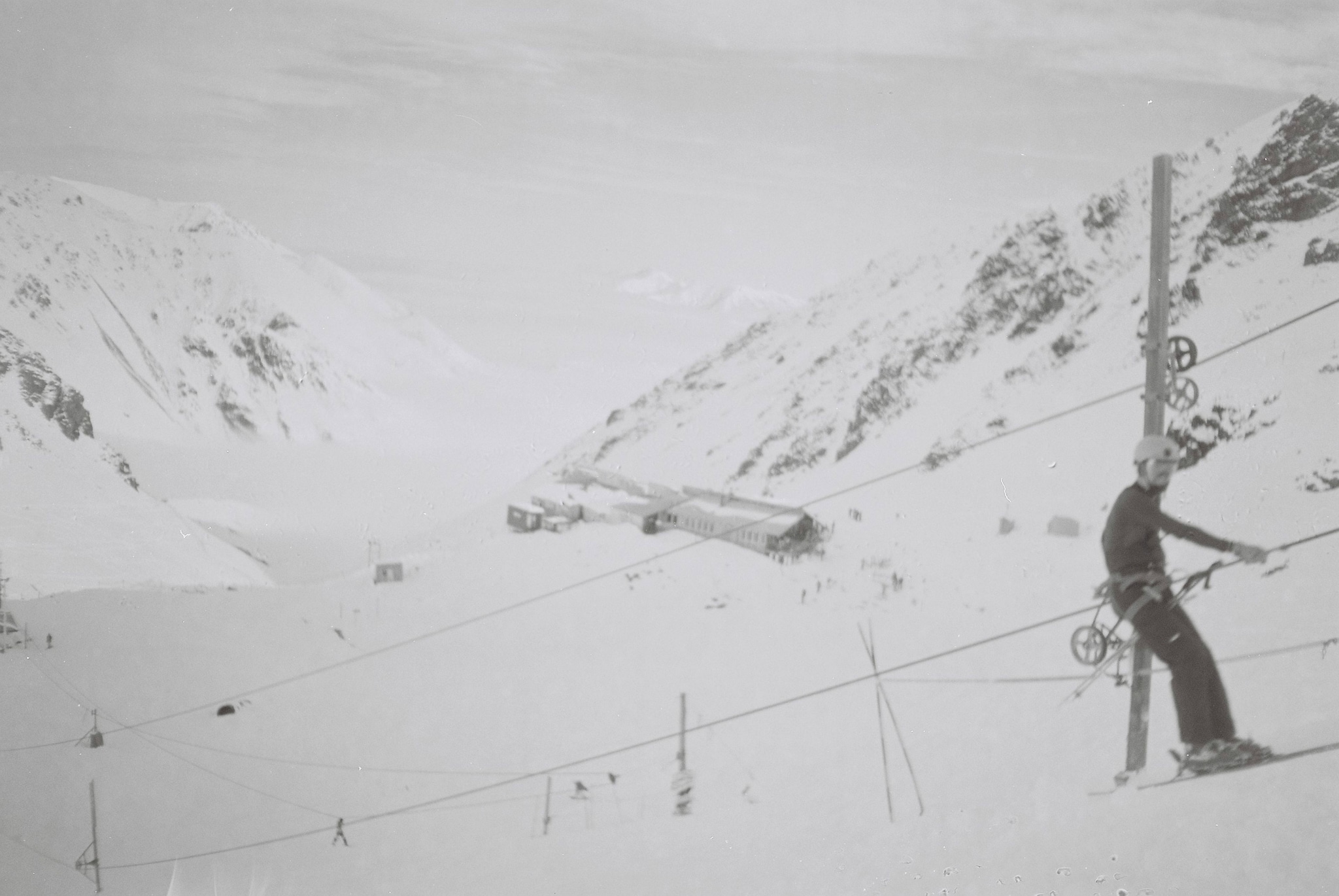 Skiing Snow Mountain Slope Skier Lift Cable Pole Winter Cold Outdoor Sport Landscape White Black-and-white Snowy Hillside Glacier Ice Alpine Adventure Recreation Travel Nature Scenery Chairlift Equipment Gear Frozen Remote Rugged Terrain Primary White