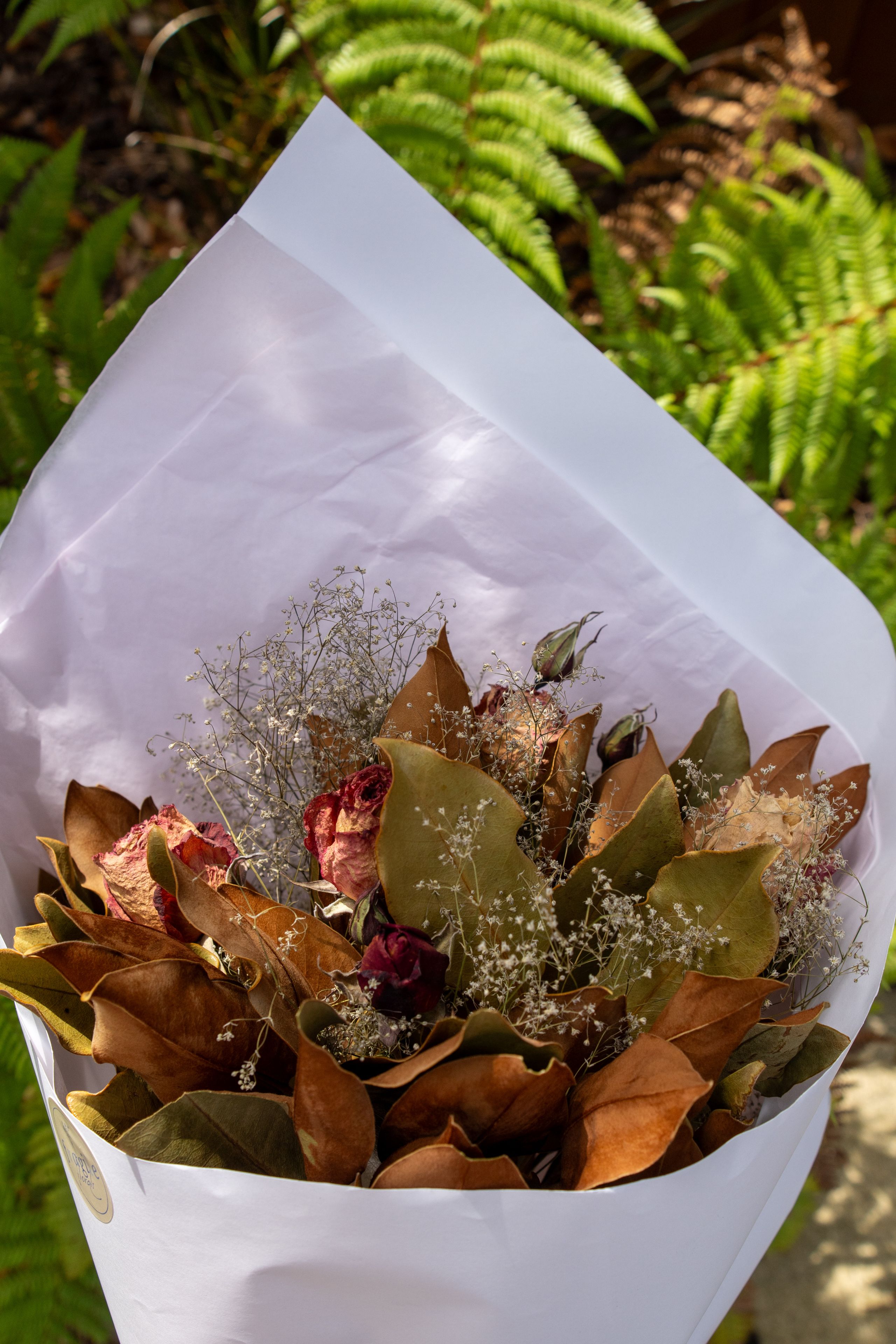 Bouquet Flowers Dried Leaves White Paper Wrapping Ferns Green Brown Red Stems Arrangement Nature Outdoors Floral Gift Botanical Texture Background Natural Light Wrinkled Petals Foliage Stemmed Plant Wrapping Paper Drying Arrangement Wrinkled Petals