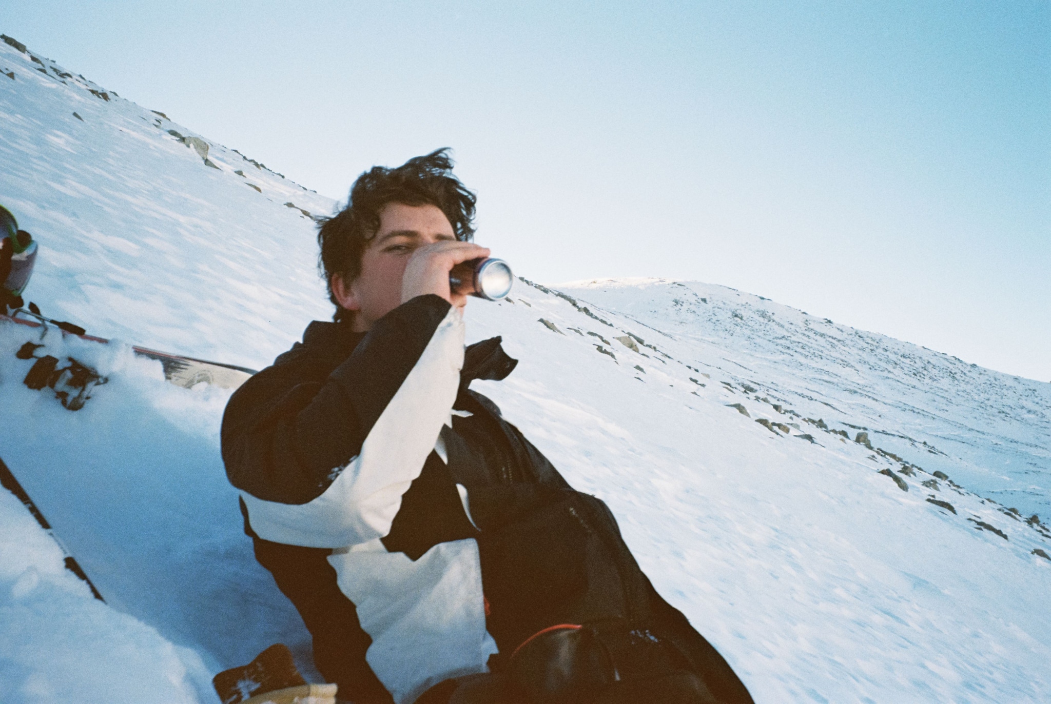 Person Snow Mountain Drinking Bottle Jacket Winter Blue Sky Cold Outdoor Relaxing Slope White Black Beverage Landscape Leisure Adventure Nature Scenery Chill Refreshment Recreation Calm Peaceful Quiet Solitude Tranquility